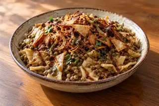 Harraq Isbao (Lentils with Dough & Pomegranate)